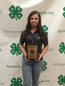 4-Her Jessica Wells accepted a Florida 4-H Community Pride Top 5 Project award on behalf of the Fire Ants 4-H Club at 4-H University.