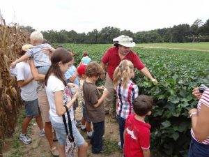 Ag Agent Jed Dillard teaching youth about cotton. Do you know how many pairs of jeans you can make out of a bale of cotton?