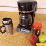coffee maker with mug and fruit